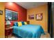 Guest bedroom with teal bedding, red and yellow pillows at 9950 E Sundance Trl, Scottsdale, AZ 85262