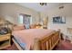 Bedroom with wooden bed frame and ensuite bathroom at 9950 E Sundance Trl, Scottsdale, AZ 85262