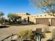 Beautiful stucco home with a three-car garage and desert landscaping at 9950 E Sundance Trl, Scottsdale, AZ 85262