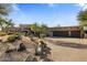 Desert landscape surrounds this single-story home with three-car garage at 9950 E Sundance Trl, Scottsdale, AZ 85262