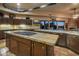 Open kitchen with large granite island and stunning sunset views at 9950 E Sundance Trl, Scottsdale, AZ 85262