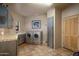 Laundry room with washer, dryer, and built-in cabinets at 9950 E Sundance Trl, Scottsdale, AZ 85262