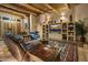 Spacious living room with a built-in entertainment center and wood beams at 9950 E Sundance Trl, Scottsdale, AZ 85262