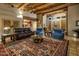 Comfortable living room with a fireplace and wood beam ceilings at 9950 E Sundance Trl, Scottsdale, AZ 85262