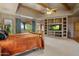 Main bedroom with built-in shelving and a fireplace at 9950 E Sundance Trl, Scottsdale, AZ 85262