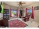Home office with a large window, built-in shelves and comfortable seating at 9950 E Sundance Trl, Scottsdale, AZ 85262