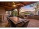 Covered patio with dining area, mountain views, and built-in grill at 9950 E Sundance Trl, Scottsdale, AZ 85262