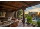 Covered patio with outdoor seating and pool views at 9950 E Sundance Trl, Scottsdale, AZ 85262