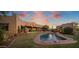 Expansive backyard with a sparkling pool and grassy lawn at 9950 E Sundance Trl, Scottsdale, AZ 85262