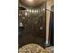 Large walk-in shower with dark granite walls and pebble floor at 9950 E Sundance Trl, Scottsdale, AZ 85262