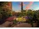 Serene water feature with a wooden bridge and lush landscaping creates a tranquil oasis at 9950 E Sundance Trl, Scottsdale, AZ 85262
