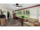 Sunroom with view of backyard, wooden floors and seating area at 10254 W Snead S Cir, Sun City, AZ 85351