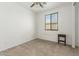 Bright bedroom with carpeted floor, window, and small side table at 10838 W Buchanan St, Avondale, AZ 85323