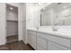 Bright bathroom featuring a double vanity, modern fixtures, and wood-look tile floor at 12362 W Marguerite Ave, Avondale, AZ 85323
