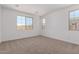 Clean and modern bedroom with plush carpet, bright windows, and white walls for a serene retreat at 12362 W Marguerite Ave, Avondale, AZ 85323