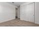 Bright bedroom featuring neutral carpet, white walls, and a closet with sliding doors at 12362 W Marguerite Ave, Avondale, AZ 85323