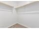 Empty walk-in closet featuring clothes rods and neutral carpet flooring at 12362 W Marguerite Ave, Avondale, AZ 85323