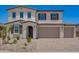 Charming two-story home boasts a three-car garage, desert landscaping, and a stylish mix of stucco and tile accents at 12362 W Marguerite Ave, Avondale, AZ 85323