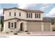 Two-story house with brown roof and shutters, attached three-car garage at 12362 W Marguerite Ave, Avondale, AZ 85323