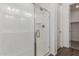 Modern glass shower with chrome fixtures and a built-in niche next to a walk-in closet at 12362 W Marguerite Ave, Avondale, AZ 85323