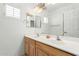 Bright bathroom with a double sink vanity and a large mirror with decorative lighting at 12739 W Merrell St, Avondale, AZ 85392