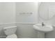 Bathroom features a pedestal sink, toilet, and modern finishes at 12739 W Merrell St, Avondale, AZ 85392