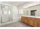 Bright bathroom features a glass enclosed shower, soaking tub, and double sink vanity at 12739 W Merrell St, Avondale, AZ 85392