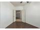 Bedroom with wood-look flooring, white walls, and an open doorway to the hallway at 12739 W Merrell St, Avondale, AZ 85392