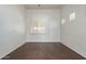 Spacious bedroom featuring wood-look floors, neutral walls, and a large window with shutter blinds at 12739 W Merrell St, Avondale, AZ 85392