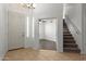 Inviting entryway with tile flooring, white walls, and staircase to the second floor at 12739 W Merrell St, Avondale, AZ 85392