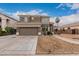Two-story house with a brown exterior, two-car garage, and landscaped yard at 12739 W Merrell St, Avondale, AZ 85392