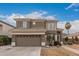 Two-story house with a brown exterior, two-car garage, and landscaped yard at 12739 W Merrell St, Avondale, AZ 85392