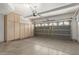 Spacious garage with ample storage cabinets and an automatic door opener, perfect for parking and organization at 12739 W Merrell St, Avondale, AZ 85392