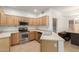 Bright kitchen boasts light wood cabinets, stainless steel appliances, and tile flooring at 12739 W Merrell St, Avondale, AZ 85392