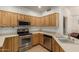 Kitchen features stainless steel appliances, light wood cabinets, and sleek countertops at 12739 W Merrell St, Avondale, AZ 85392