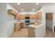 Well-lit kitchen with light wood cabinets, tile flooring, and stainless steel appliances at 12739 W Merrell St, Avondale, AZ 85392