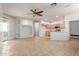 Open-concept living space with tile flooring, kitchen area and large sliding glass doors at 12739 W Merrell St, Avondale, AZ 85392