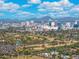This aerial view shows the city skyline with lush landscaping and a nearby golf course at 1618 W Culver St, Phoenix, AZ 85007