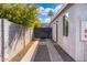 View of a charming backyard with a stone path, lush foliage, and privacy fencing at 1618 W Culver St, Phoenix, AZ 85007