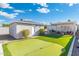 Spacious backyard with artificial turf, putting green, and a covered patio at 1618 W Culver St, Phoenix, AZ 85007