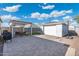 This backyard offers a brick patio, pergola with seating, basketball hoop, and detached garage at 1618 W Culver St, Phoenix, AZ 85007