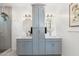 Bright bathroom featuring double sinks, gray cabinets, modern lighting fixtures, and ample counter space at 1618 W Culver St, Phoenix, AZ 85007