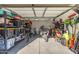 The garage interior has storage shelves, a workspace and room for bicycles and a motorcycle at 1618 W Culver St, Phoenix, AZ 85007