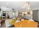Bright, open-concept living room with a modern chandelier, large sectional, and a view of the kitchen at 1618 W Culver St, Phoenix, AZ 85007