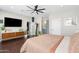 Main bedroom with a ceiling fan, hardwood floors, walk in closet, and ensuite bathroom at 1618 W Culver St, Phoenix, AZ 85007