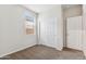 Simple bedroom with neutral walls, carpet flooring and double door closet at 1791 W Sombra Ave, Apache Junction, AZ 85120