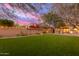 Landscaped backyard with artificial turf and raised garden beds at 18196 N 92Nd St, Scottsdale, AZ 85255