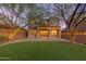 Spacious backyard with artificial turf, string lights, and a pavered patio at 18196 N 92Nd St, Scottsdale, AZ 85255