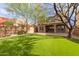 Large backyard with lush green lawn and a patio area at 18196 N 92Nd St, Scottsdale, AZ 85255