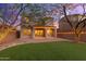 Home's back with a landscaped yard, string lights, and brick patio at 18196 N 92Nd St, Scottsdale, AZ 85255